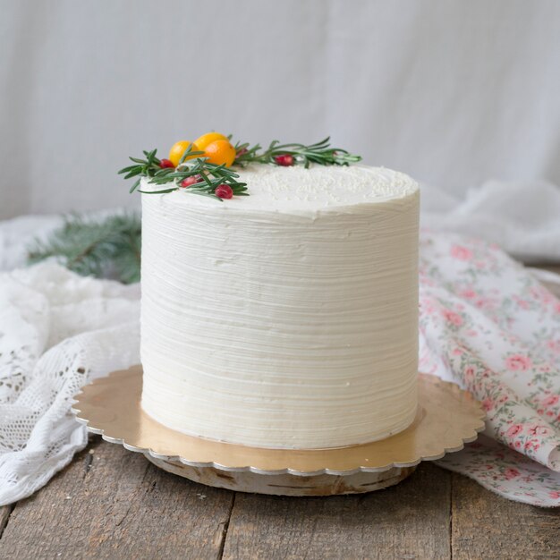 Torta di Natale o Capodanno, decorata con kumquat, rametti di rosmarino e mirtilli rossi.