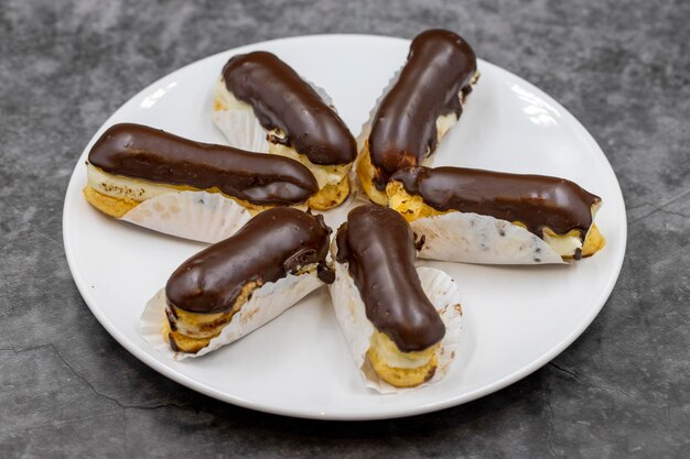 Torta eclair al cioccolato su sfondo scuro dessert tradizionale francese prodotti pasticceria da vicino