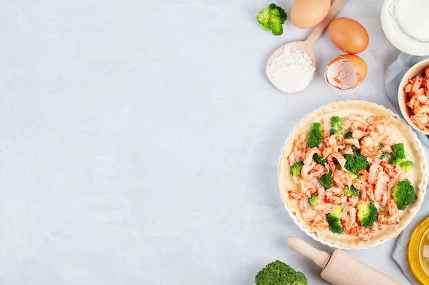 Torta salata francese fatta in casa con gamberi e broccoli ripieni di crema e uova.