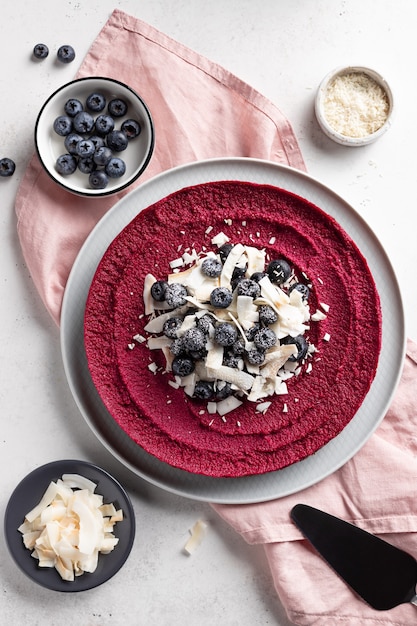 Torta vegana cruda con mirtilli e scaglie di cocco