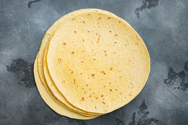 Tortillas di mais giallo fresco, su sfondo grigio, vista dall'alto laici piatta con spazio di copia