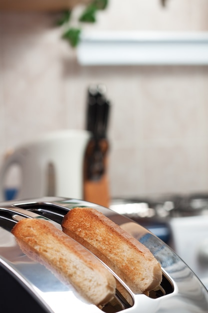 Tostapane di pane con fette di pane in cucina