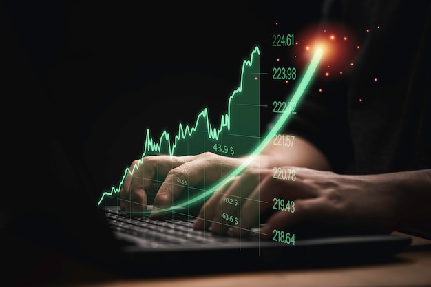 Trader che utilizza un computer portatile con un grafico e un grafico di investimento virtuale in aumento per la tendenza dell'analisi del mercato azionario e il concetto tecnico per trader.