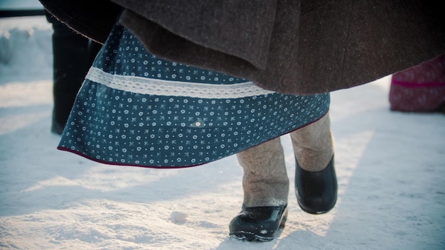 Tradizioni russe una ragazza con stivali di feltro e un vestito che balla in inverno