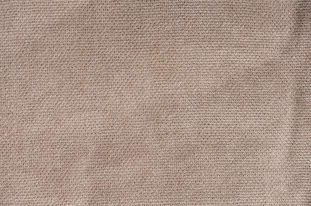 Trama del tessuto beige da vicino per lo sfondo