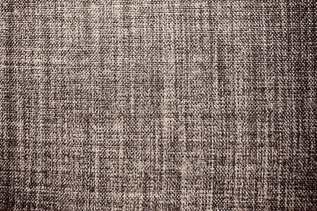 Trama del tessuto di sfondo marrone Un pezzo di stoffa di lana è ben disposto sulla superficie Trama del tessuto e del tessuto Tessuto del vestito o per la cucina ha bisogno di tovaglie o tende primo piano Dash