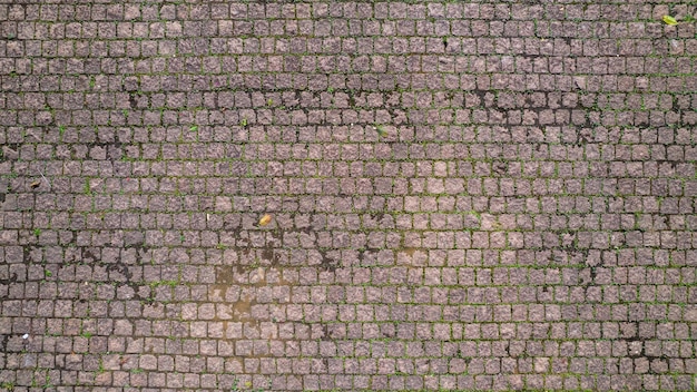 Trama di ciottoli. Vecchio pavimento in pietra, pavimentazione in pietra.