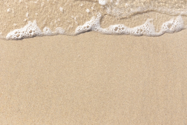 Trama di sfondo spiaggia di sabbia. Spiaggia di sabbia bagnata