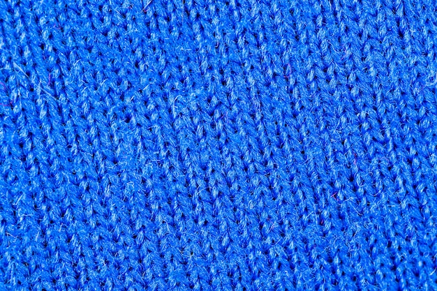 Trama di tessuto blu di cotone naturale o materiale tessile di lino, primo piano di panno di maglione blu caldo, sfondo ad alta risoluzione