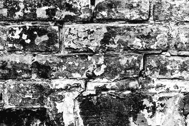 Trama di un muro di mattoni con crepe e graffi che possono essere utilizzati come sfondo