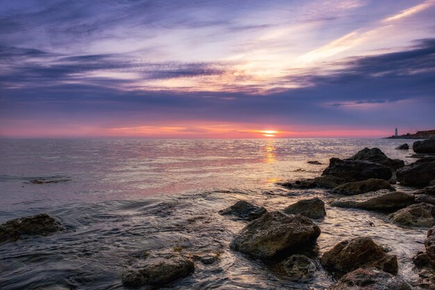 Tramonto spettacolare sulla spiaggia con uno stagno naturale in primo piano