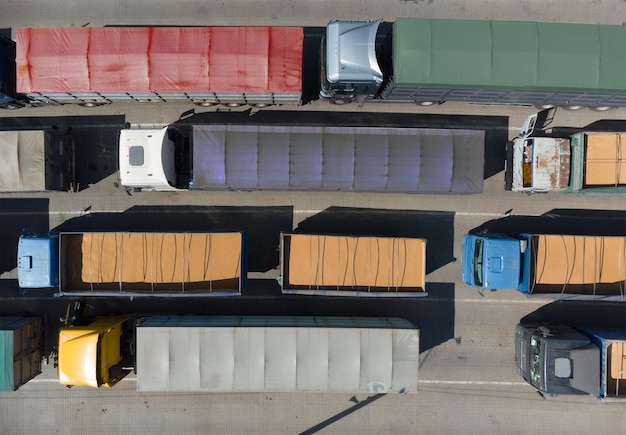 Trasporto merci Molti camion stanno aspettando in fila per lo scarico nel porto vista dall'alto del porto da un quadrirotore su camion carichi di grano