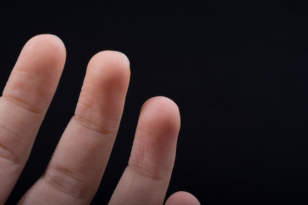 Tre dita di una mano umana parzialmente viste in vista
