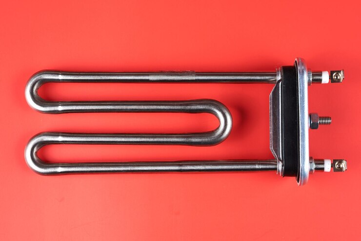 Tubular electric Heating element made of steel for washing machines boiling water heating isolated on red background