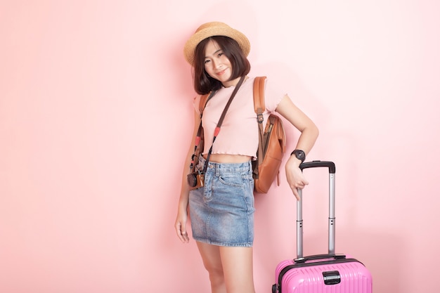 Turista asiatico felice della donna sulla parete rosa