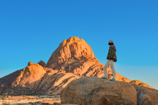 Turista donna attiva viaggia nella riserva naturale di Spitzkoppe ragazza viaggiatore escursionismo Namibia