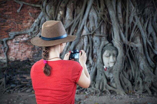 Turista e Testa di Buddha in Thailandia