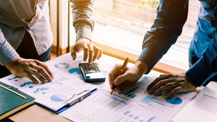 Two businessman team calculate about summary report annual on table office