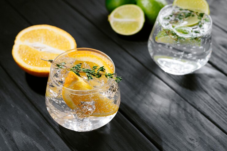 Two glasses with an alcoholic cocktail on a wooden dark background hard seltzer is a lowalcoholic dr