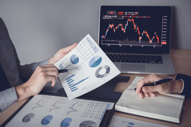 Two investors are working together with analyzing the stock data graphs