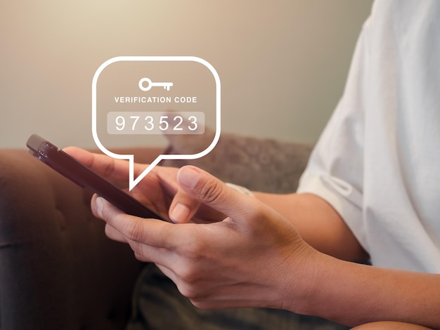 Two steps authentication or 2FA concept Verification code numbers with key icon appear when casual female person in white shirt using smart phone for validate password page Identity verification