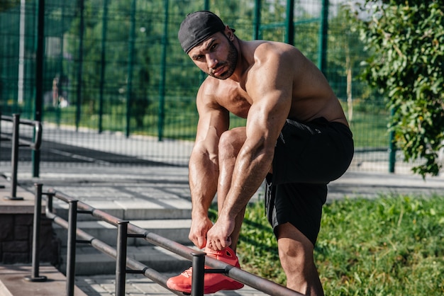 Un atleta fitness si allena su un campo sportivo. Uno stile di vita sano