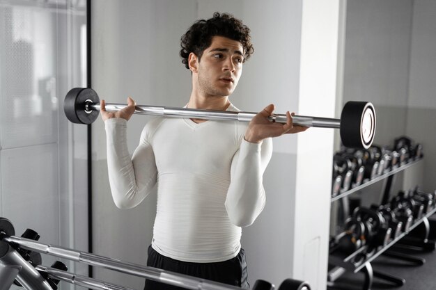 Un atleta uomo con uno stile di vita sano fa esercizi di allenamento cardio in palestra Concetto di fitness