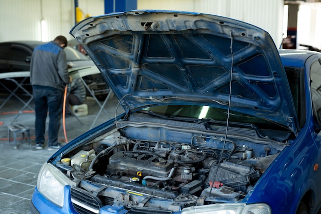 Un'auto con il cofano aperto in servizio