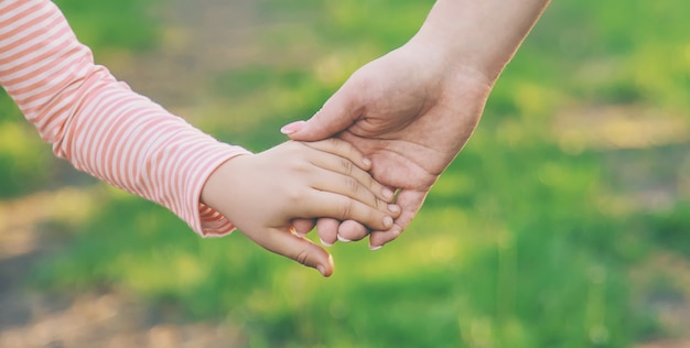 Un bambino con sua madre passa per mano