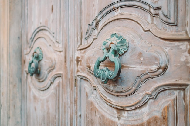 Un battente di porta di ferro antico su una porta di legno Pisa Italia