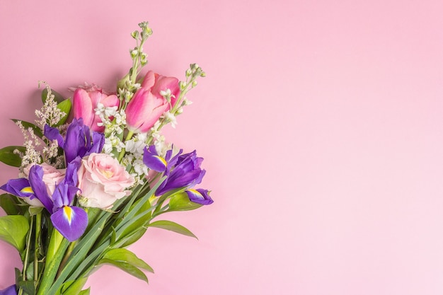 Un bellissimo bouquet di fiori freschi su una superficie rosa pastello