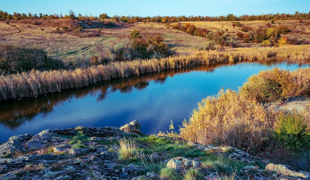 Un bellissimo fiume scintillante tra grandi pietre bianche e vegetazione verde sulle colline in Ucraina