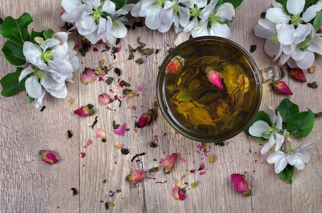 un bicchiere di tè con fiori e foglie