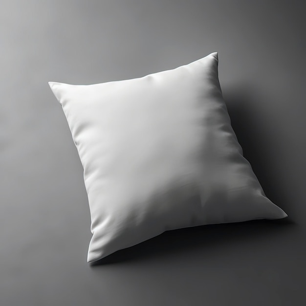 Un cuscino bianco con un cuscino bianco su sfondo grigio.