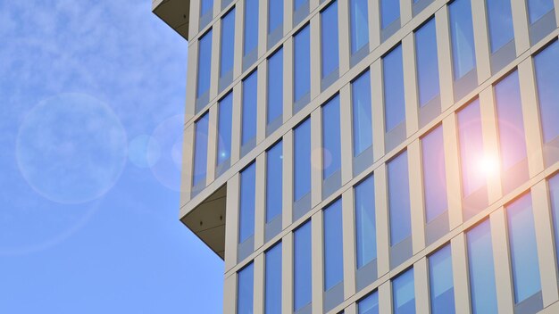 un edificio con un cielo azzurro e il sole che vi si riflette