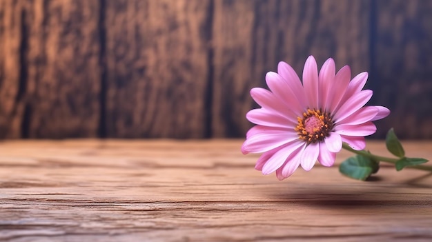 Un fiore rosa su un tavolo di legno