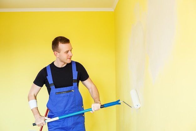 Un giovane fa delle riparazioni all'appartamento, ok ridipinge le pareti in un colore diverso