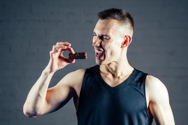 Un giovane rifiuta cioccolato e zucchero in palestra