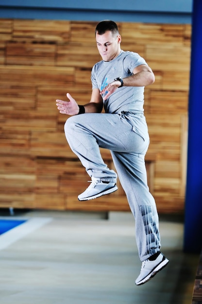 un giovane uomo sano esercita attività ricreative di fitness e yoga al coperto