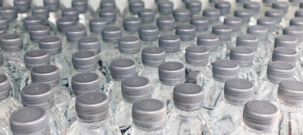 un gran numero di prodotti per l'acqua in bottiglia di plastica in attesa di essere venduti ai supermercati