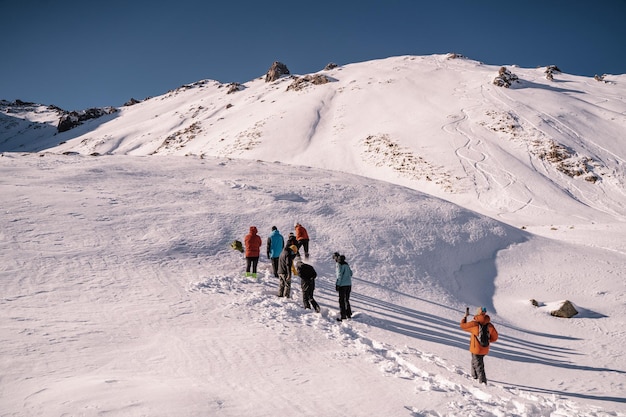 Un gruppetto di persone si arrampica su un pendio innevato