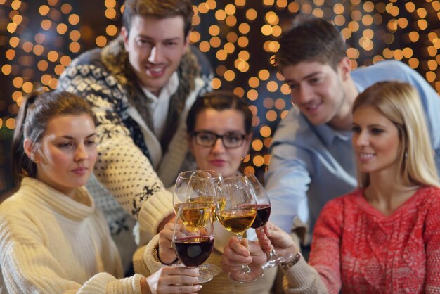 Un gruppo di giovani felici beve vino al ristorante discoteca party