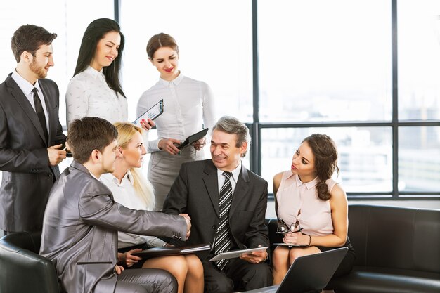 Un gruppo di uomini d'affari che discutono la politica dell'azienda in ufficio.