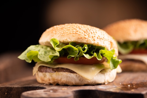 Un hamburger fresco e gustoso e patatine fritte sul tavolo di legno