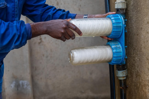 Un idraulico africano sostituisce i filtri dell'acqua