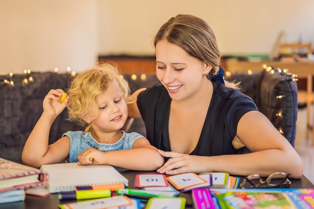 Un insegnante un tutor per la scuola a domicilio e un insegnante a tavola O mamma e figlia Homeschooling