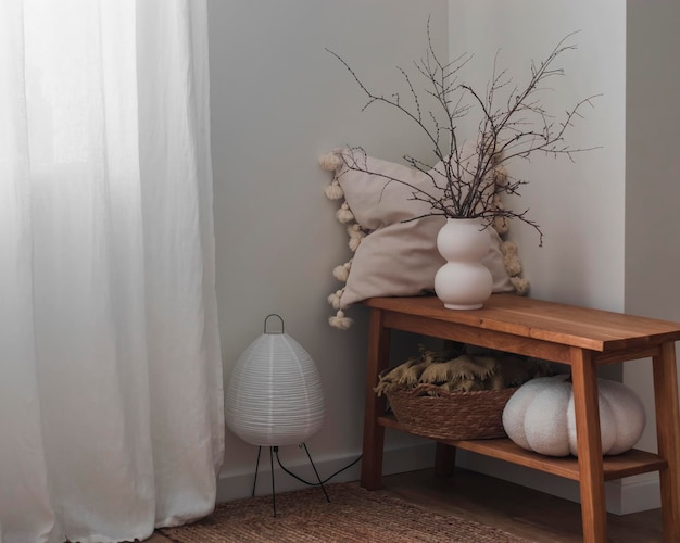 Un interno accogliente in stile scandinavo minimalista una panchina di legno con decorazione una lampada di carta sul pavimento un tappeto di iuta