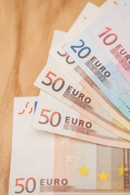Un mucchio di banconote in euro su un tavolo di legno
