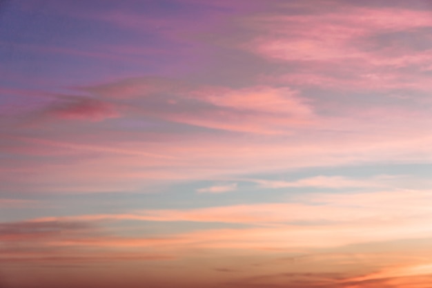 Un paesaggio nuvoloso con nuvole rosa al tramonto.