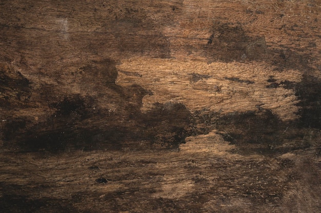 Un pavimento in legno con uno sfondo marrone scuro e bianco.